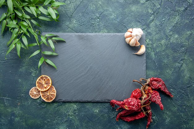 Top view gray platten with dried pepper on dark blue background color photo cook blue sea food kitchen desk