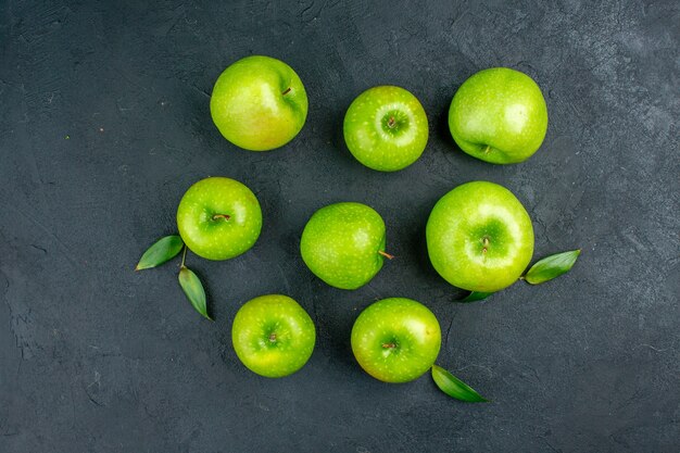 Top view green apples on dark surface