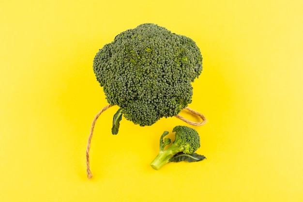 top view green broccoli fresh ripe isolated on the yellow floor