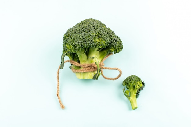 top view green broccoli isolated on the white desk