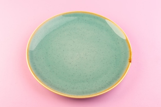 A top view green empty plate glass made for meal on pink