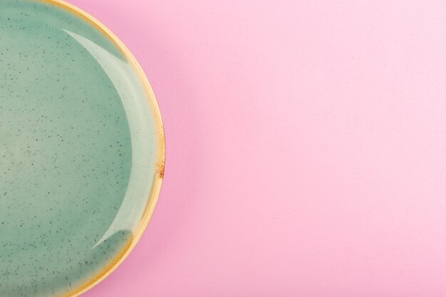 A top view green empty plate glass made for meal on pink