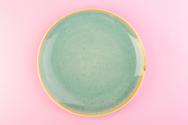 A top view green empty plate glass made for meal on pink