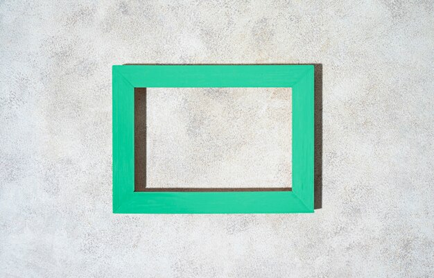 Top view green frame on textured background