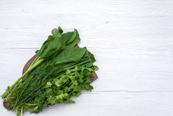 Free Photo top view green greens on the brown wooden desk and light background green vegetable leaf