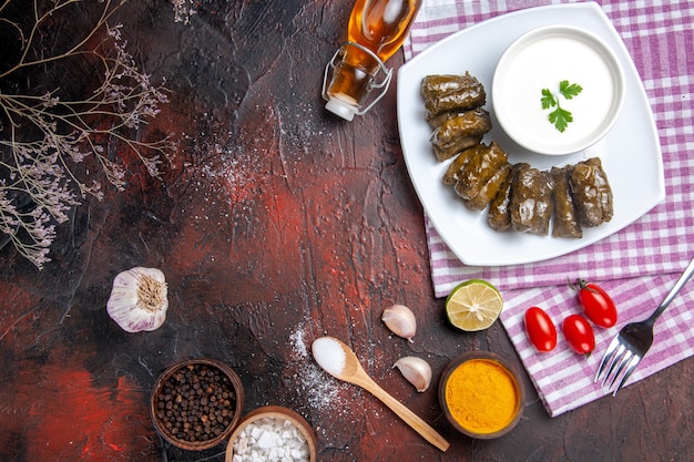 top-view-green-leaf-dolma-with-yogurt-dark-surface_140725-75424.jpg