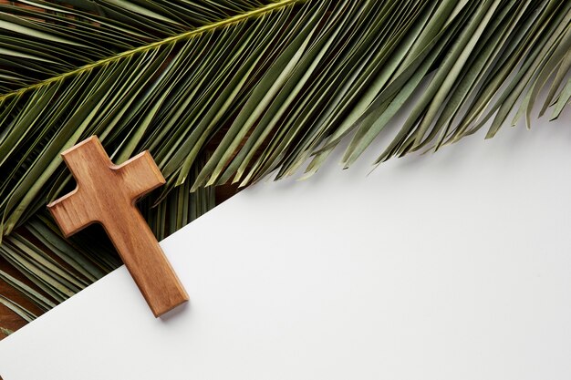 Top view green leaves and cross arrangement