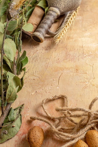 Top view of green leaves with ropes on a wooden desk