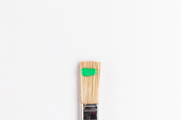 Top view of green paint on brush