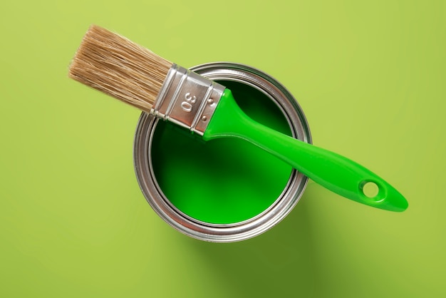 Top view green paint can and brush