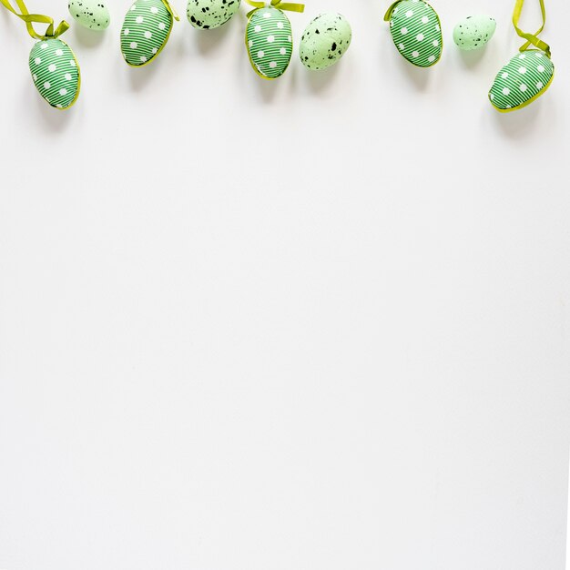 Top view green painted eggs on table