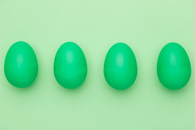 Top view green painted eggs on table