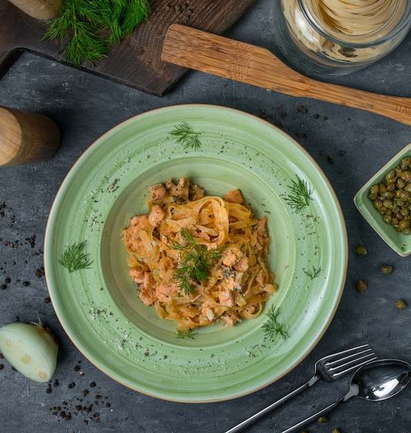 Top view green pasta bowl with herba