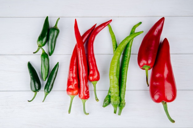 Top view of green and red hot chili peppers isolated on white