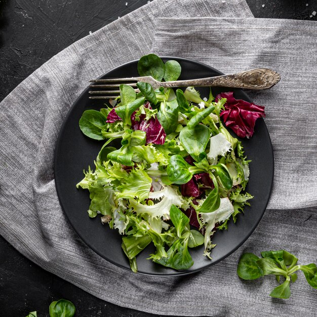 Top view green salad on dark plate