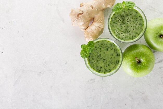 Top view of green smoothie with apples