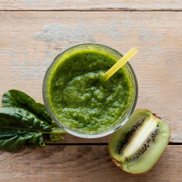 Top view green smoothie on wooden table