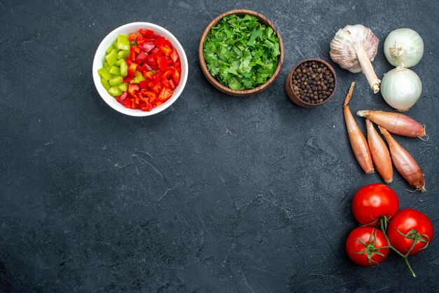 Top view greens and vegetables with pepper on grey space