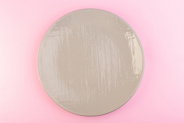 A top view grey empty plate glass made for meal on pink