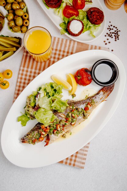 Top view of grilled seabass with fresh salad