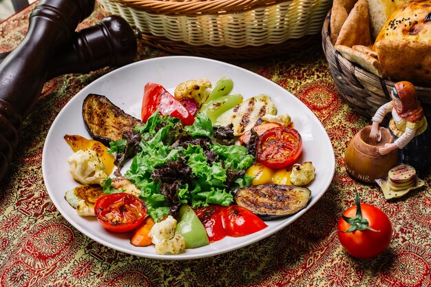 Top view grilled vegetables with salad leaves