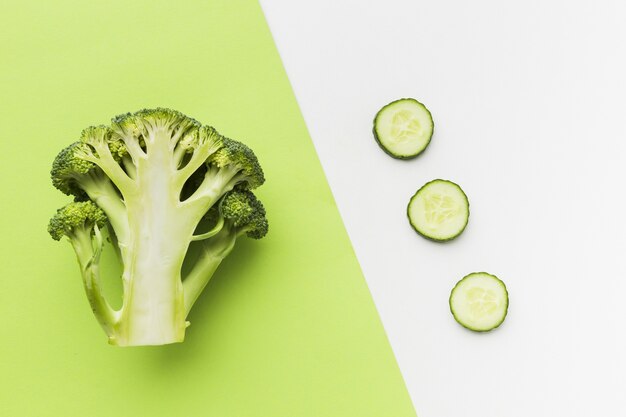 Top view of half broccoli and cucumber slices