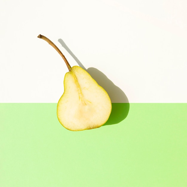 Free photo top view half of pear with shadow