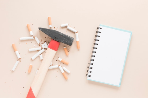 Free photo top view hammer with cigarettes