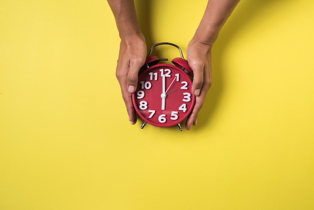 Top view hand and alarm clock