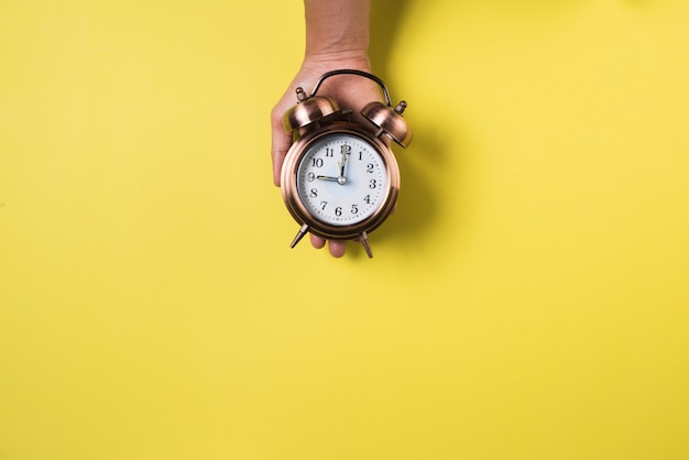 Top view hand and alarm clock