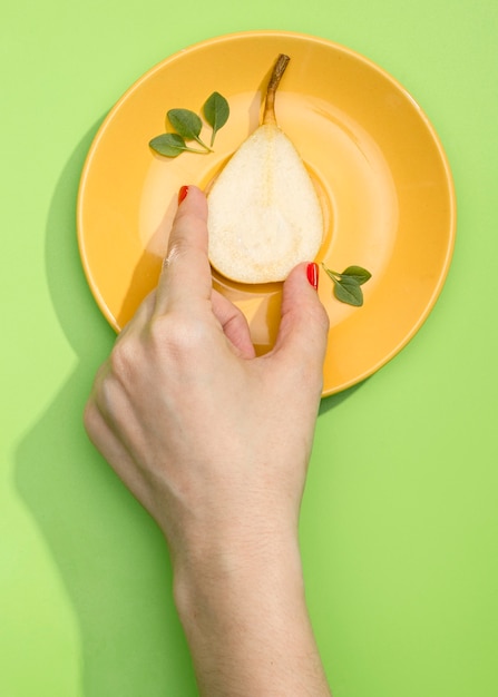 Top view hand arranging organic pear