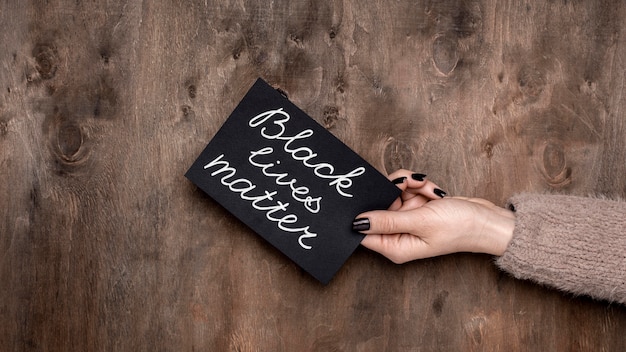 Top view of hand holding black lives matter card