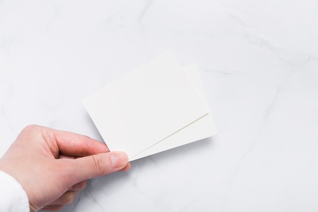 Top view hand holding blank business card