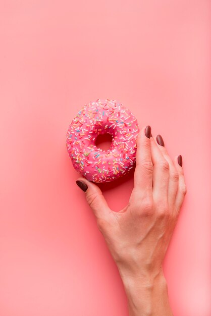 Top view hand holding donut