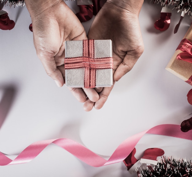 Top view Hand holding gift box on work space