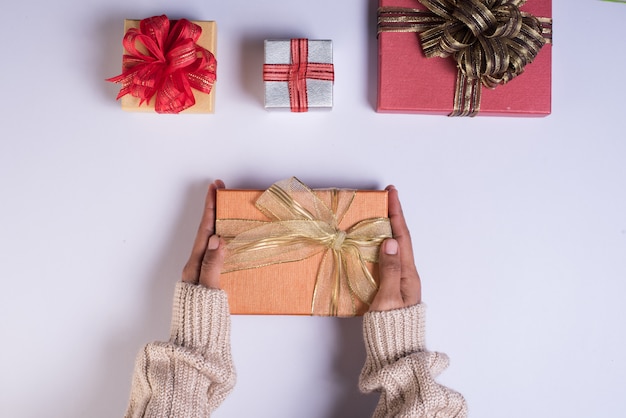 Top view Hand holding gift box on work space