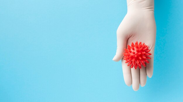 Top view of hand holding virus with copy space