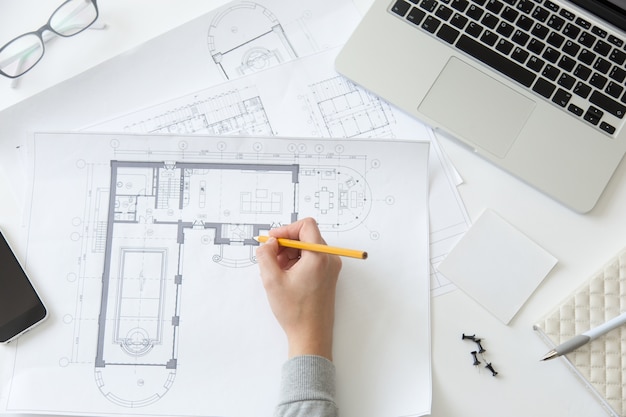 Top view of a hand making an architect drawing