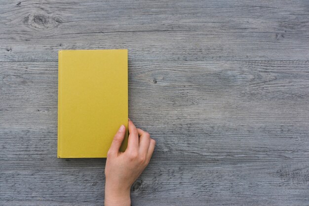 Top view of hand opening a book