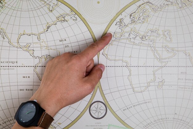 Top view hand pointing on world map 