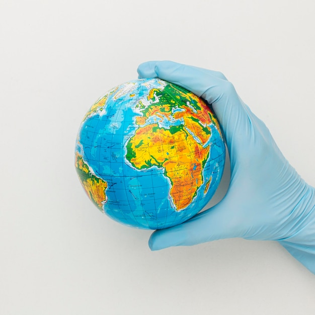 Top view of hand with gloves holding globe
