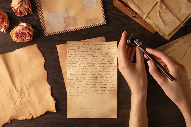 Free photo top view hand writing love letter