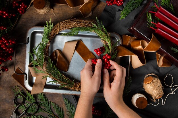 Top view hands assembling  advent wreath