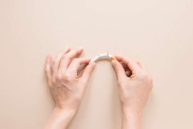 Top view hands breaking a cigarette