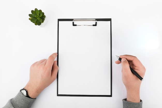 Top view of hands and clipboard