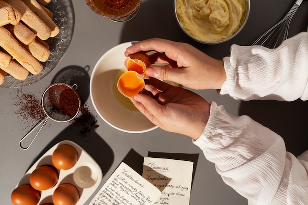 Free photo top view hands cooking tiramisu