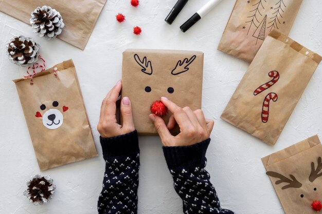 Top view of hands decorating christmas gift