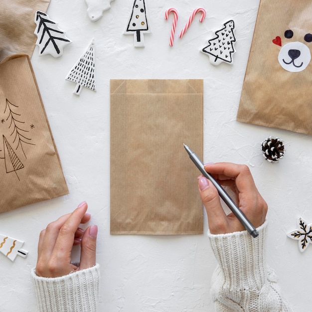 Top view of hands drawing on christmas bag