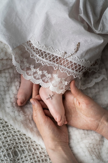 Free photo top view hands holding baby's foot