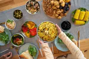 Free photo top view hands holding bowl of food